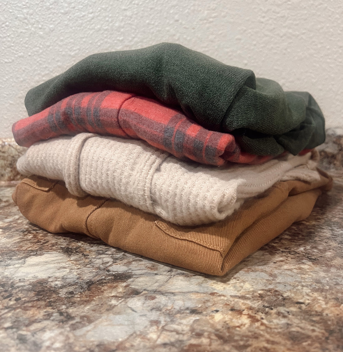 Pile of four folded sweaters