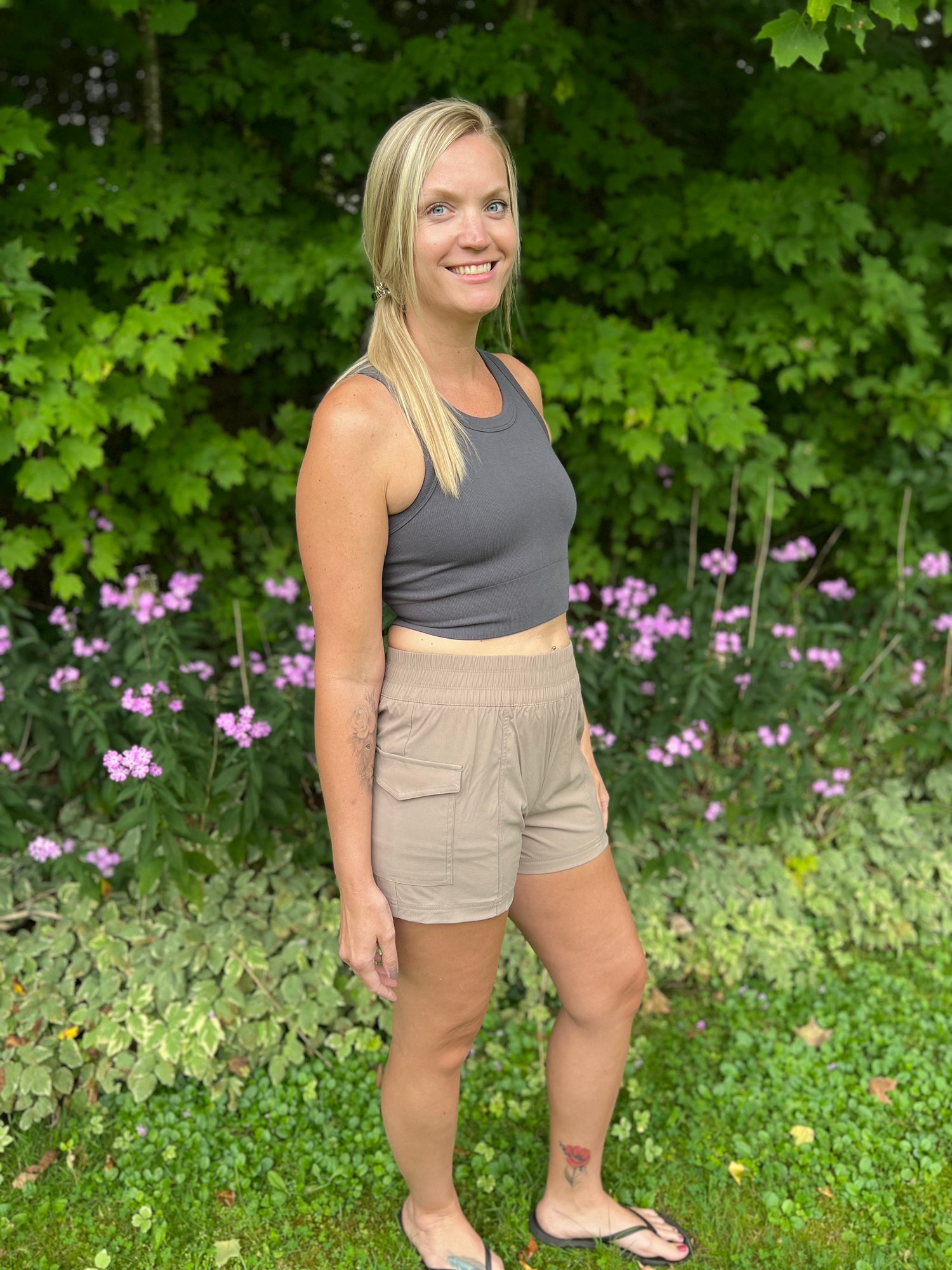 A woman wearing a charcoal high impact bra tank