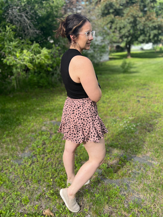 Black polka dot on tan flared shorts, almost leopard print. 