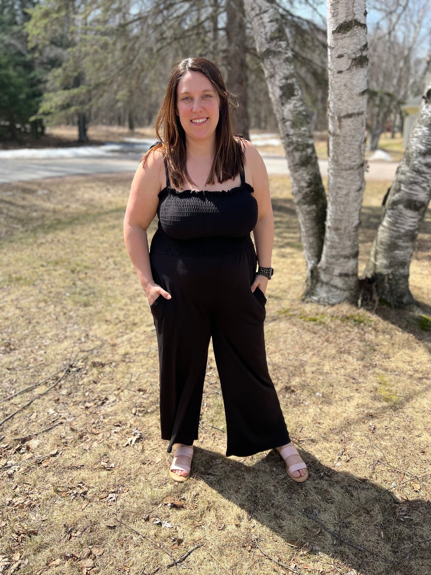 Black smocked jumpsuit with tied tank sleeves and long pants 